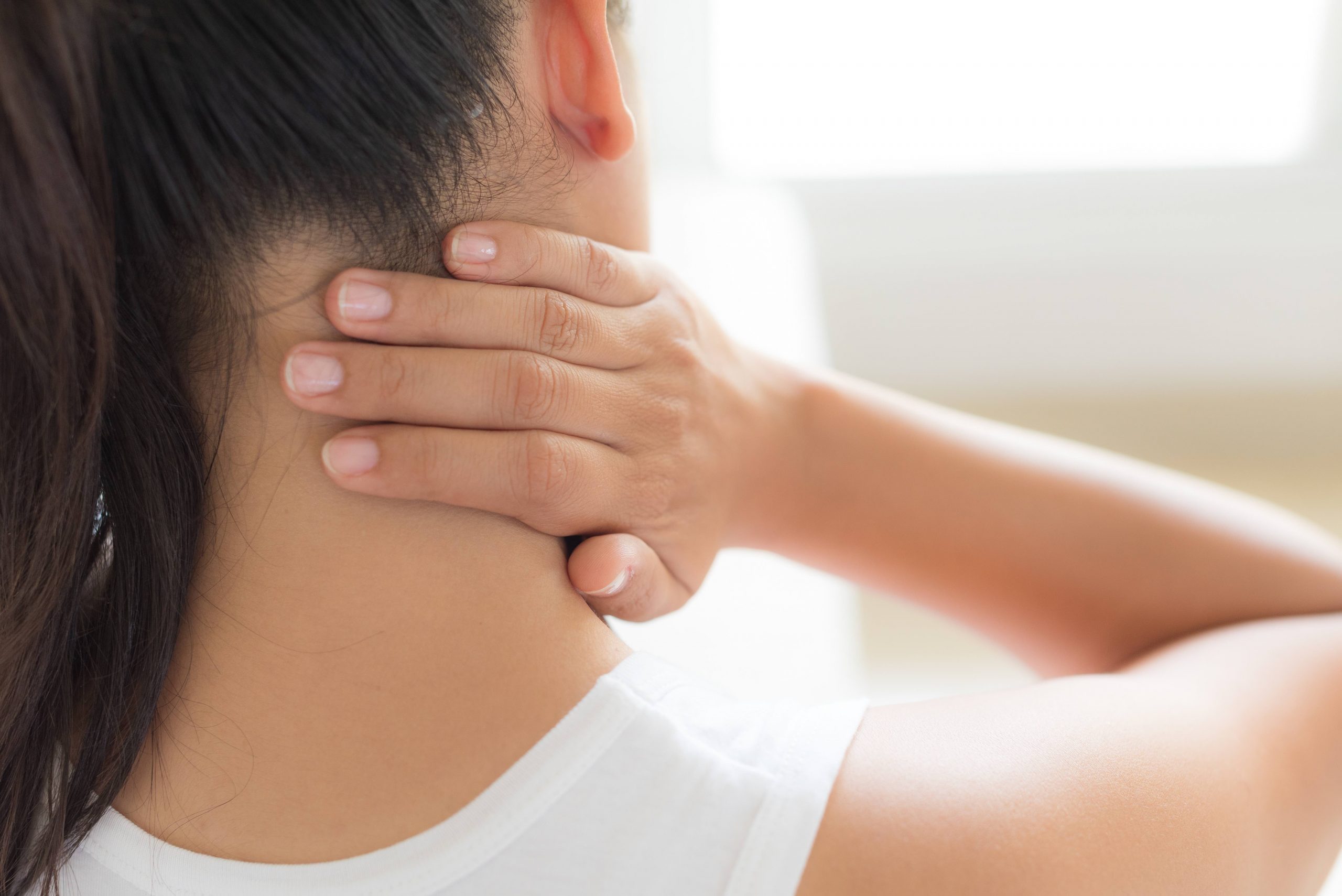 Closeup woman neck and shoulder pain and injury. Health care and medical concept. Closeup woman neck and shoulder pain and injury. Health care and medical concept.
